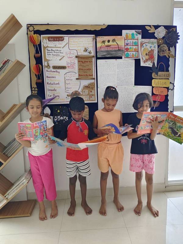 Students reading storybooks aloud in class