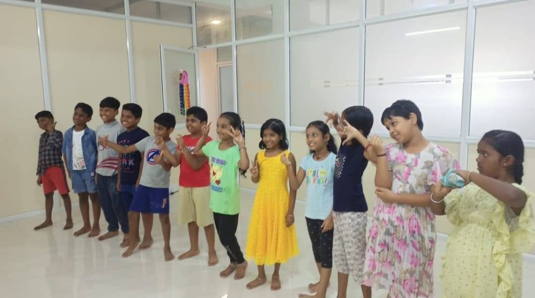 A joyful group of Thrive Academy learners posing together in class.