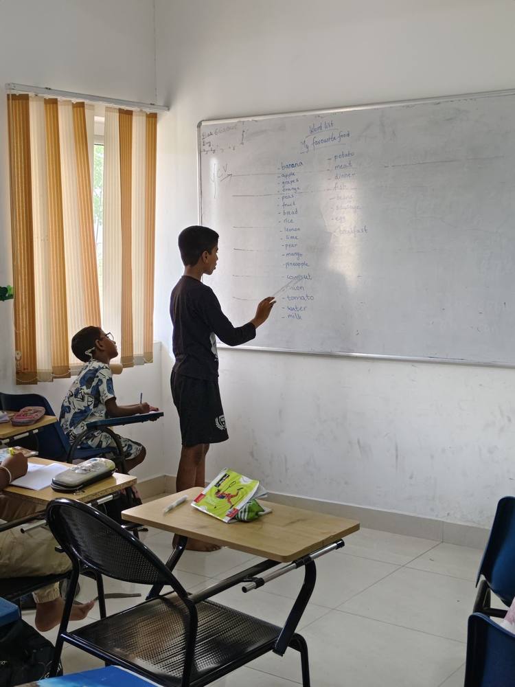 A real Thrive Academy classroom with students at a lesson board.
